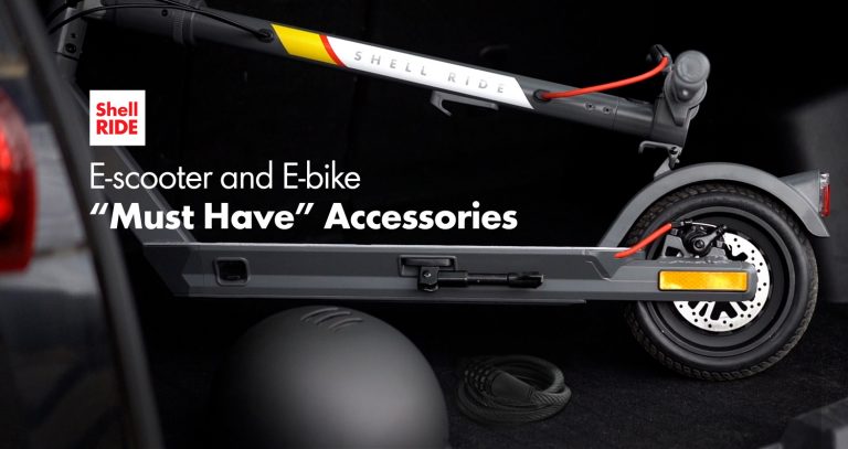 a folded Shell Ride electric scooter in the trunk of a car with a helmet and lock