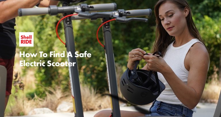 woman getting a helmet ready next to electric scooters